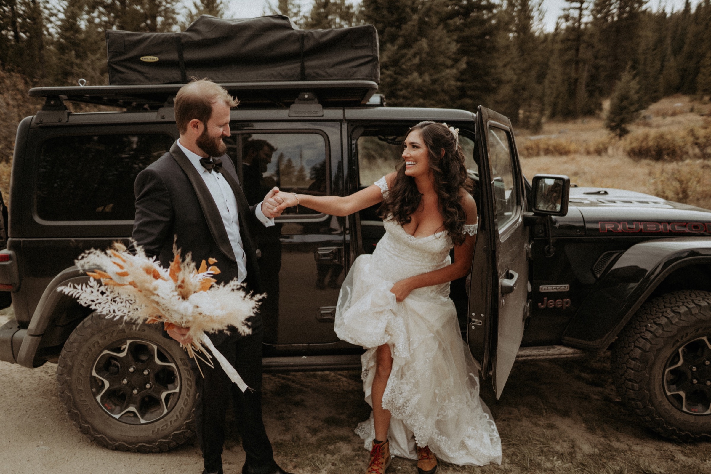 Sam helping Savanna out of a Jeep in Colorado