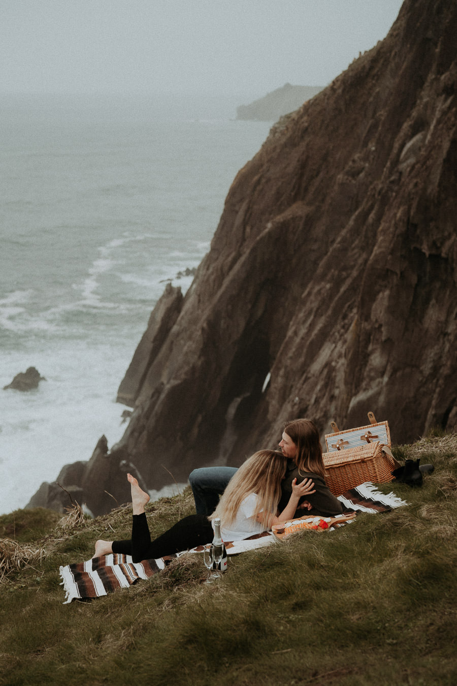 Hannah and Clay sharing a picnic above an Oregon beach