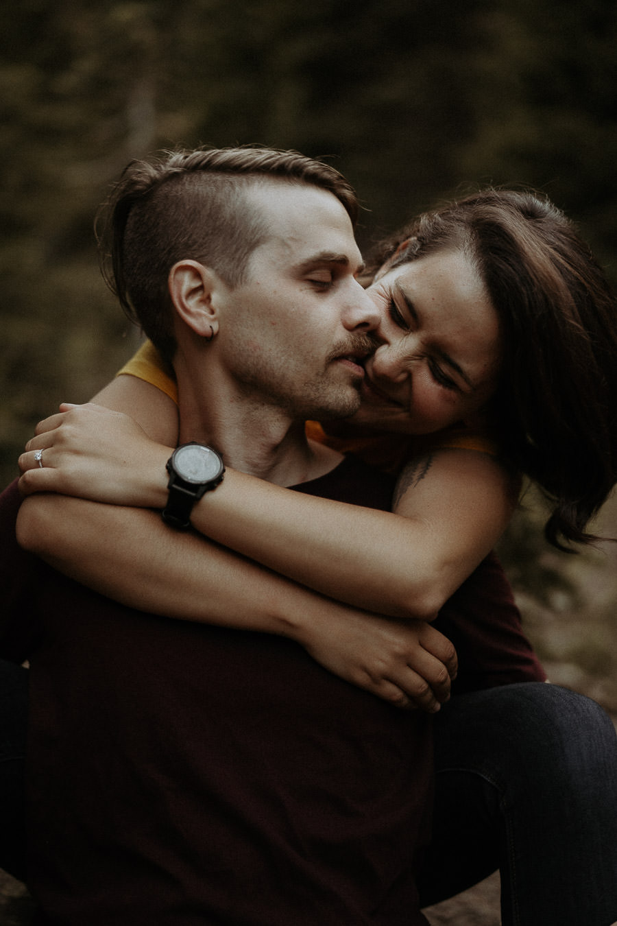Alison embracing Larry from behind during their engagement session
